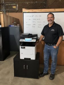 stat-business-customer-2026 - STAT Business Systems - STAT Business Systems Beef distribution company employee pictured with a newly leased Kyocera office printer